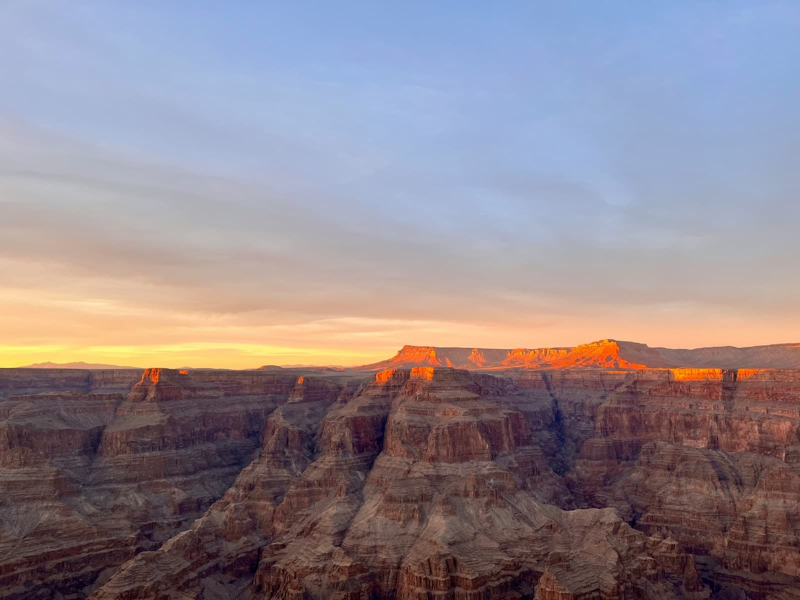 Sunlight illuminating the layered rock formations of a canyon