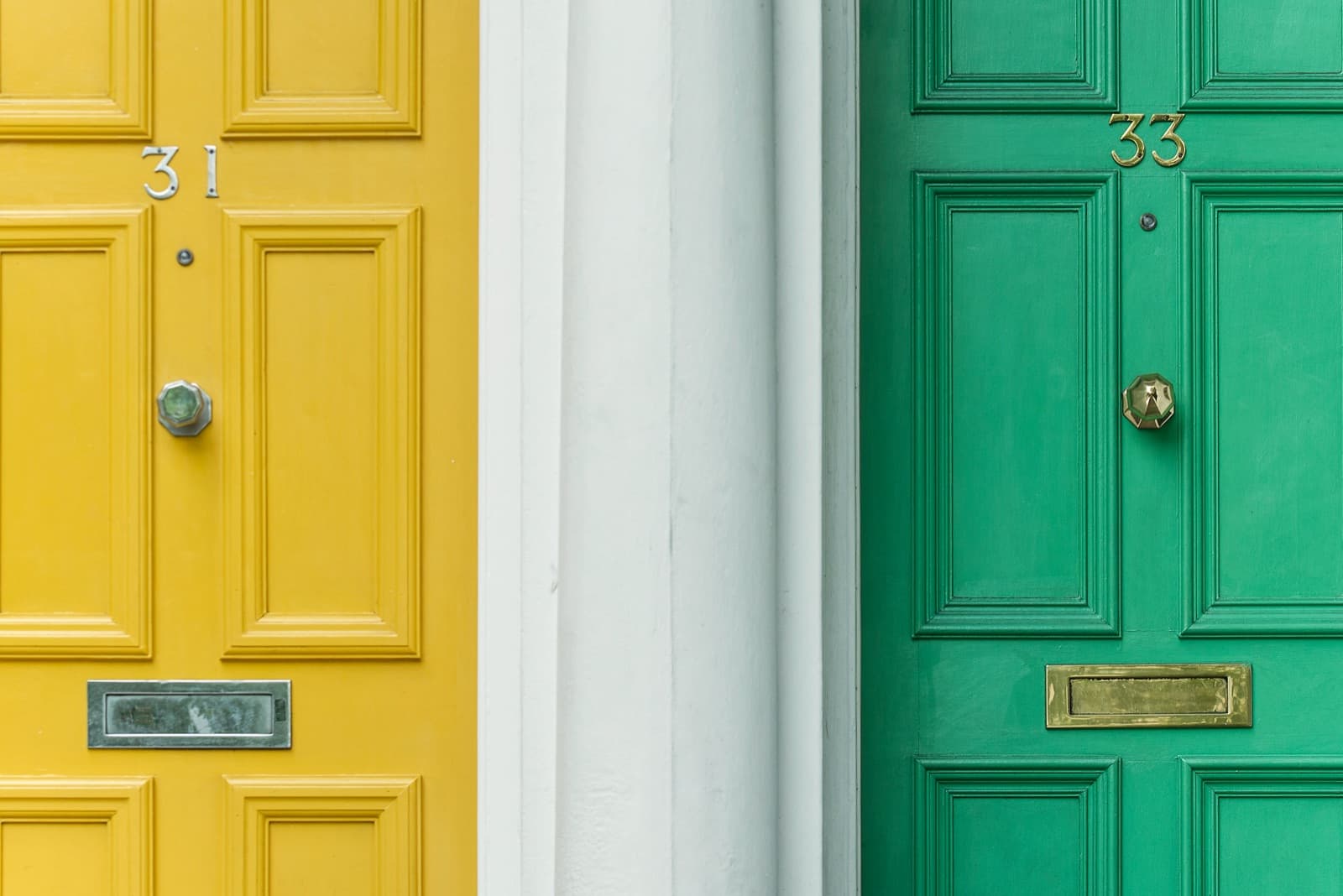 A green door and a yellow door side by side