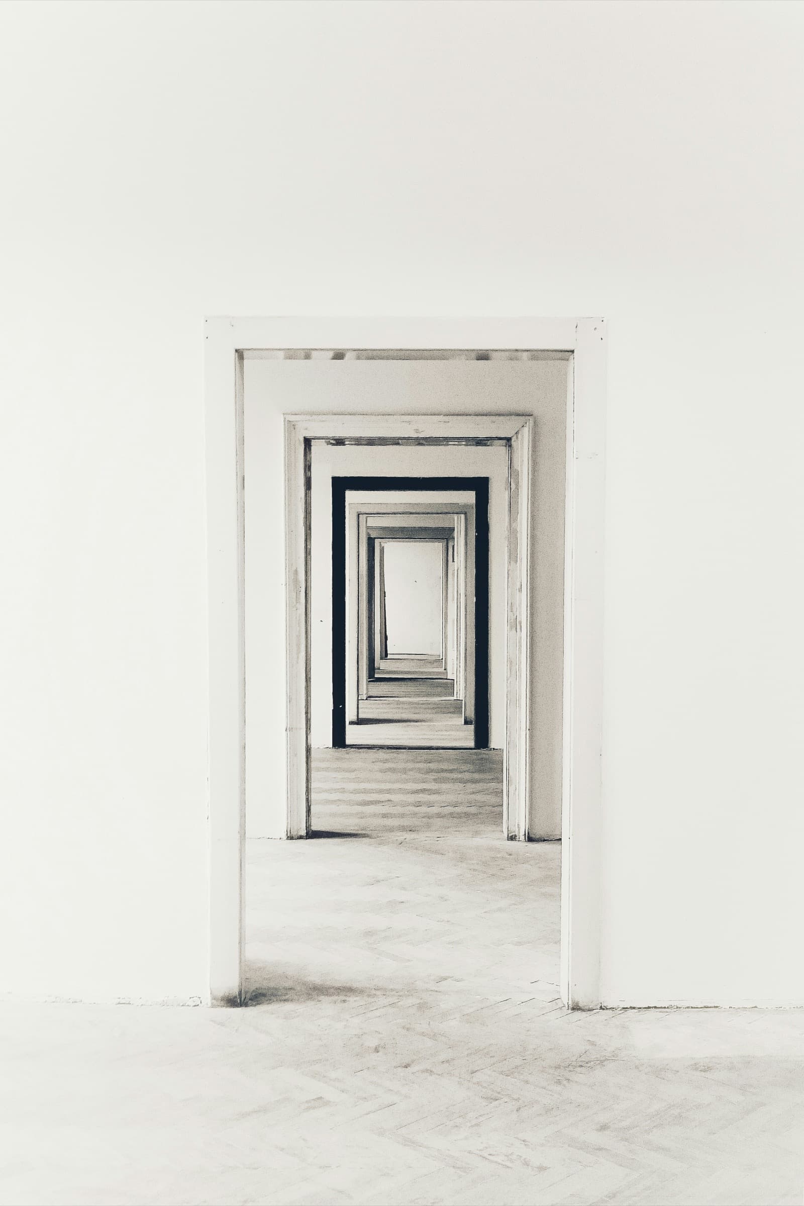 A receding sequence of open white doorways, each one visible through the one before it